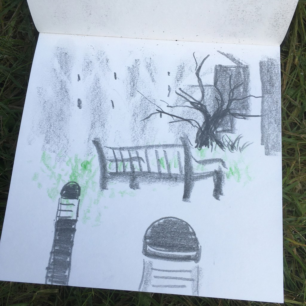 A sketch in charcoal depicting a scene with a bench and a bare tree, surrounded by grassy elements and two lamp posts, illustrating a tranquil outdoor setting.