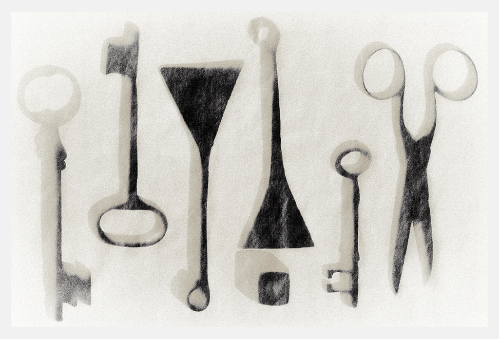 A collection of vintage tools, including keys, a scraper, and scissors, arranged artistically against a light background, showcasing their unique shapes and shadows.