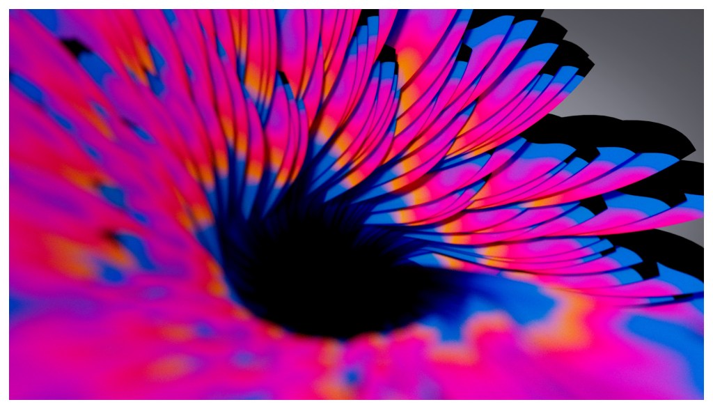 Close-up view of a vibrant, multicolored flower petal design, emphasizing swirling gradients of pink, blue, and orange hues against a dark background.