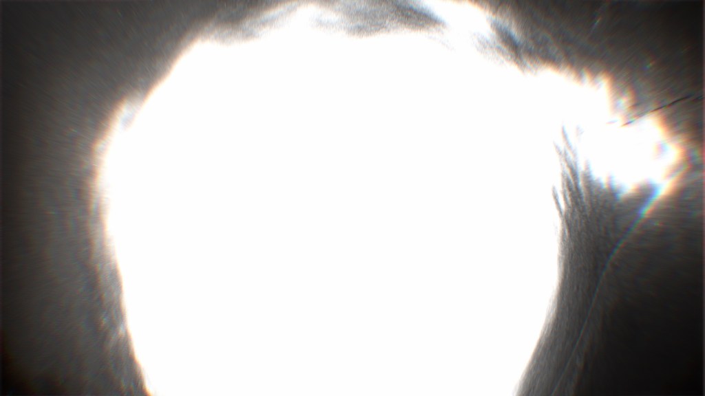 Abstract image depicting a bright, blurred orb against a dark background, evoking a sense of celestial light and space.