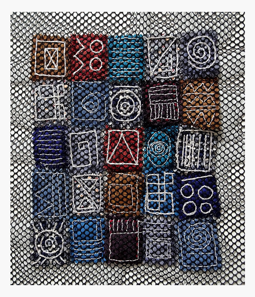 A colorful textile artwork featuring a grid of embroidered squares with various shapes and patterns, set against a mesh background.