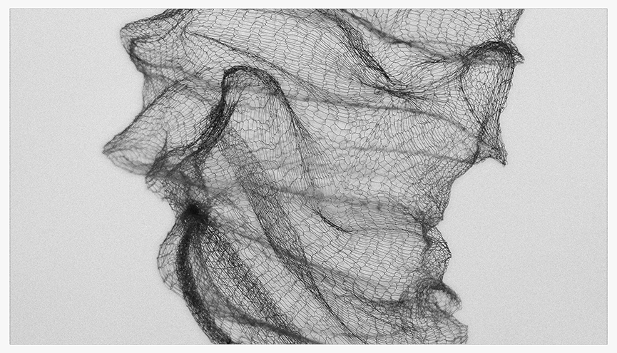 Black and white photograph of fine copper mesh, showcasing its delicate, gossamer-like texture as it flows and twists.