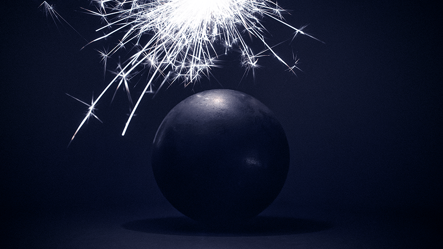A large steel ball with sparklers emitting bright sparks above it, against a dark background, creating a dramatic effect reminiscent of space themes.