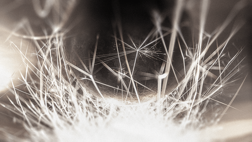 Close-up view of a large steel ball surrounded by sparker trails, creating a dynamic and ethereal atmosphere reminiscent of a satellite.