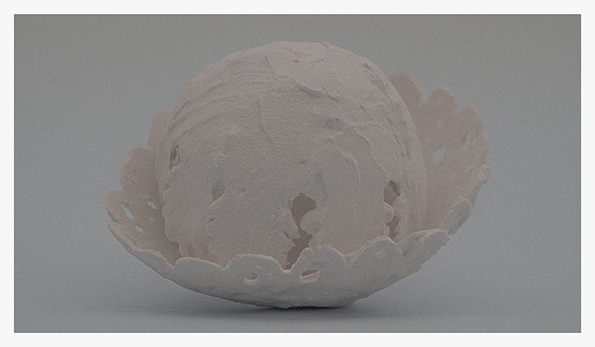 A textured, white paper mâché sphere resting inside a lace-like bowl shape.