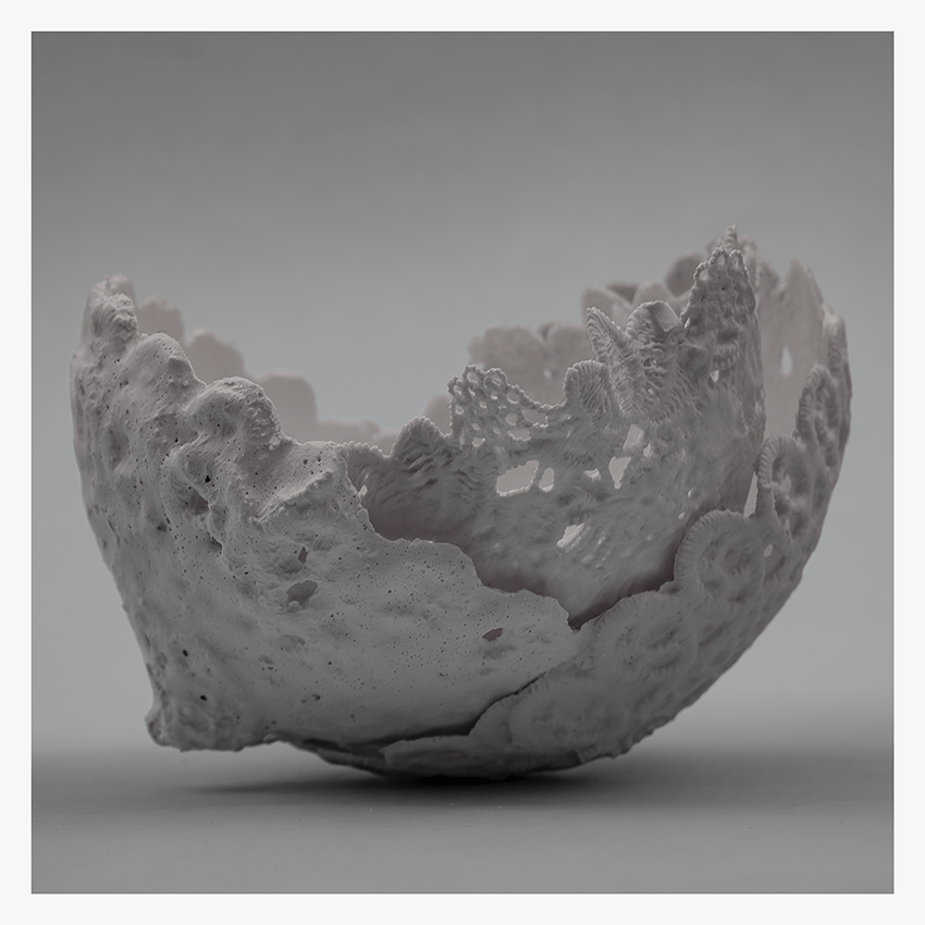 A textured, white bowl resembling lace doilies, showcasing intricate patterns and an organic, fragmented shape.