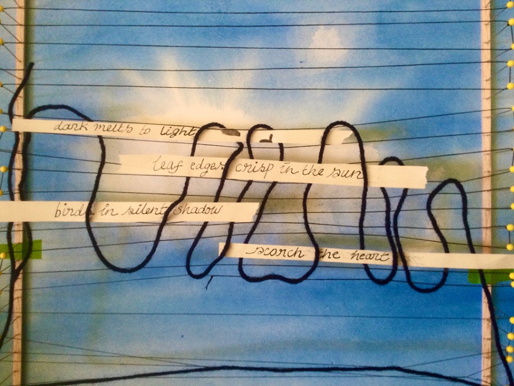 An artistic textile piece featuring a blue background with handwritten text and black threads woven across it, creating a dynamic visual composition.