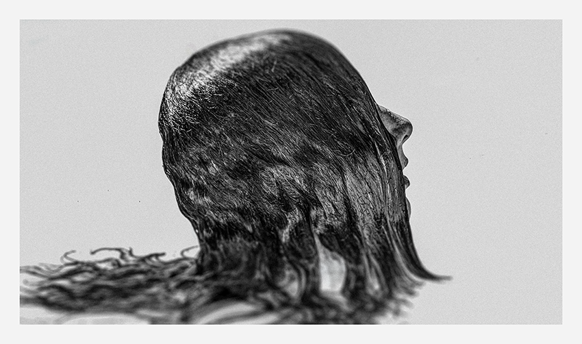 A monochrome image showcasing the silhouette of a person with long, flowing hair that appears to merge into an abstract, fluid form.